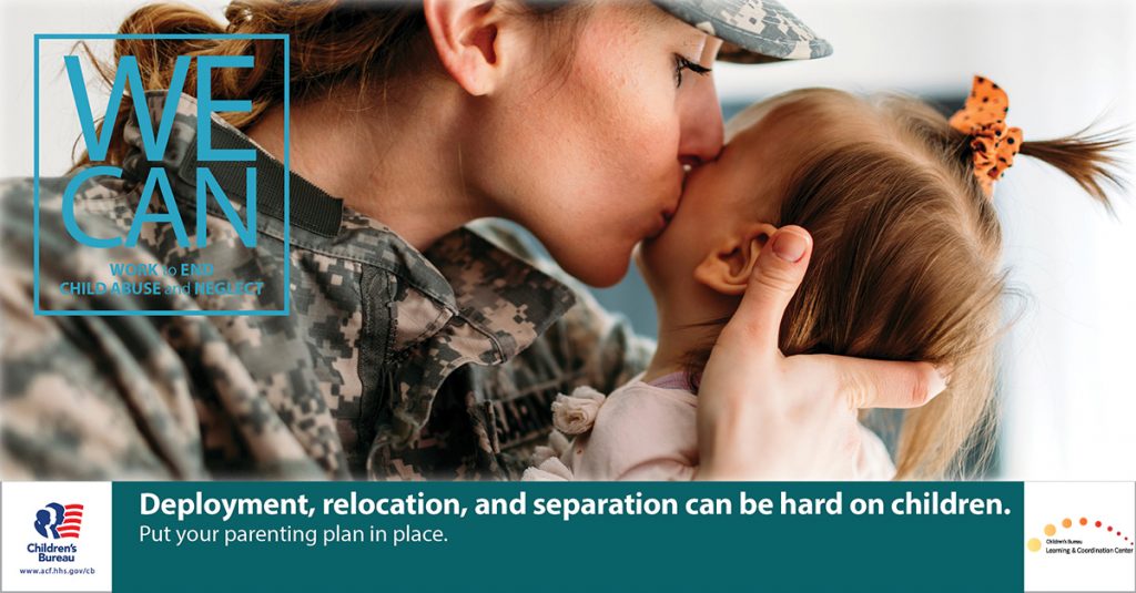 A mother in a camouflage military uniform kisses her infant child