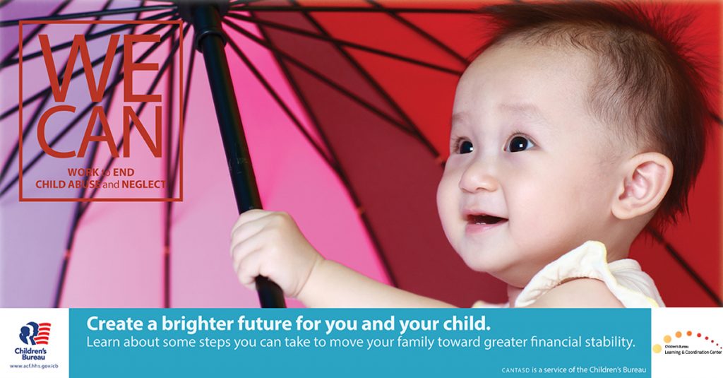 A toddler holds an umbrella and smiles
