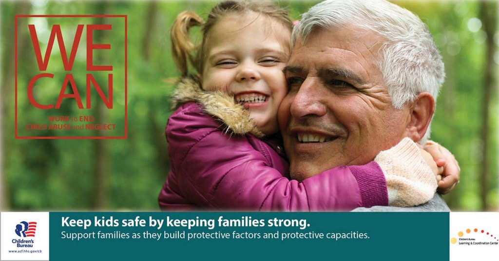 Older adult male with gray hair holds his granddaughter as both are smiling